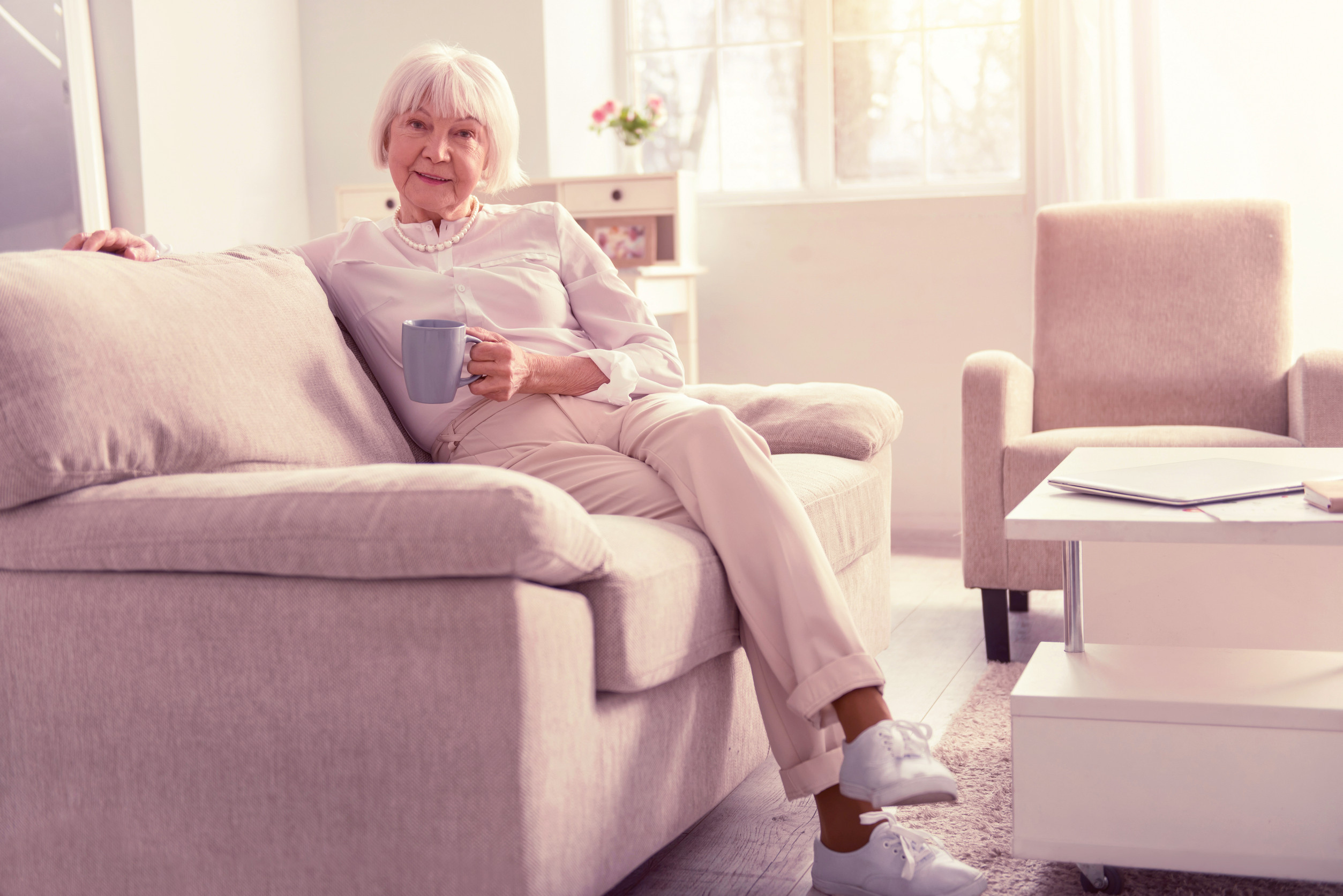 Senior sitting on a sofa in an independent living home